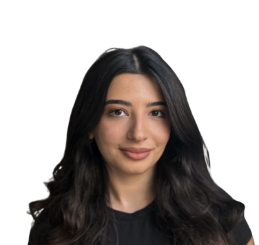 Close-up portrait of a smiling woman with long dark hair against a black background, wearing a black top.